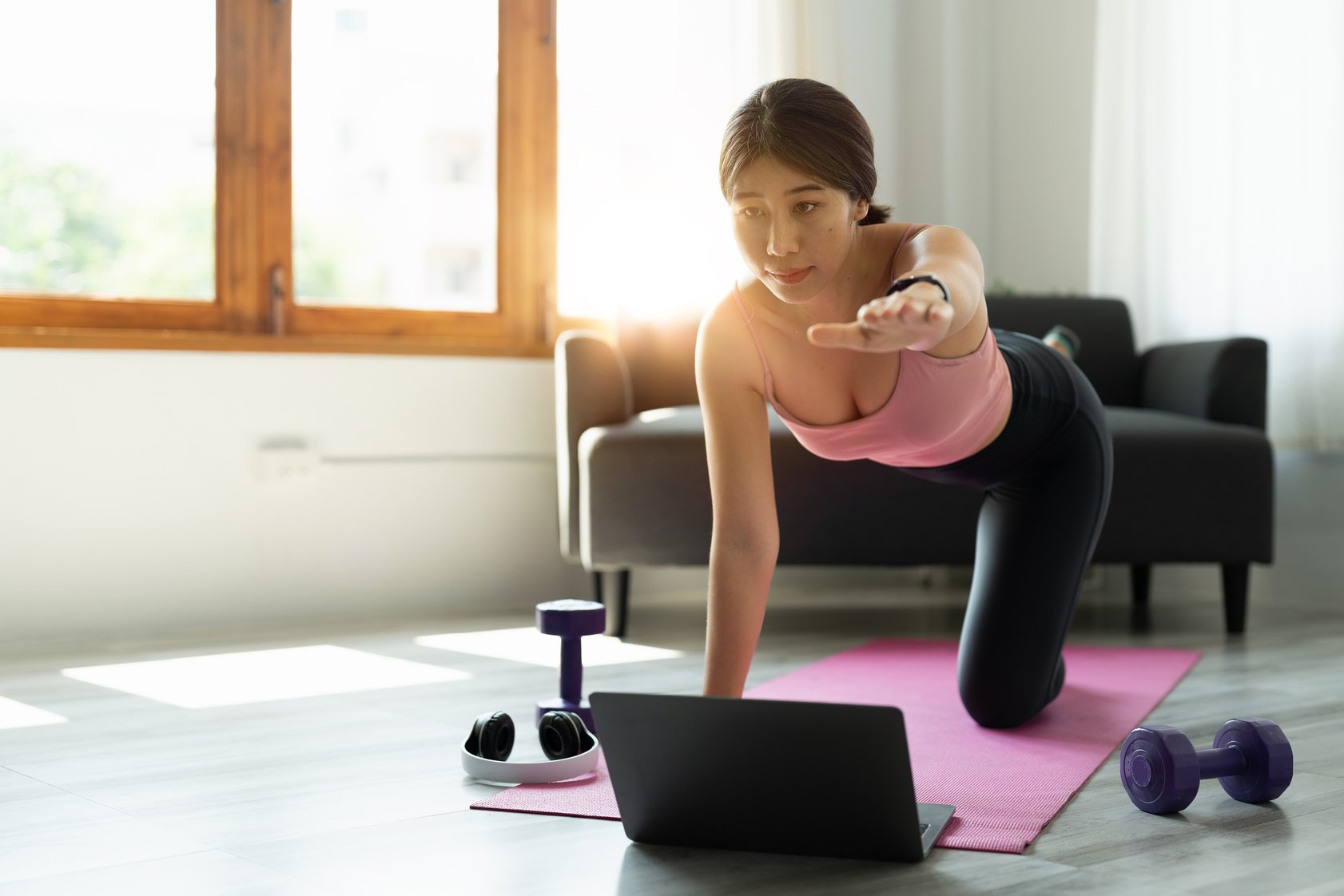 healthy sports asian woman in sportwear at home using laptop